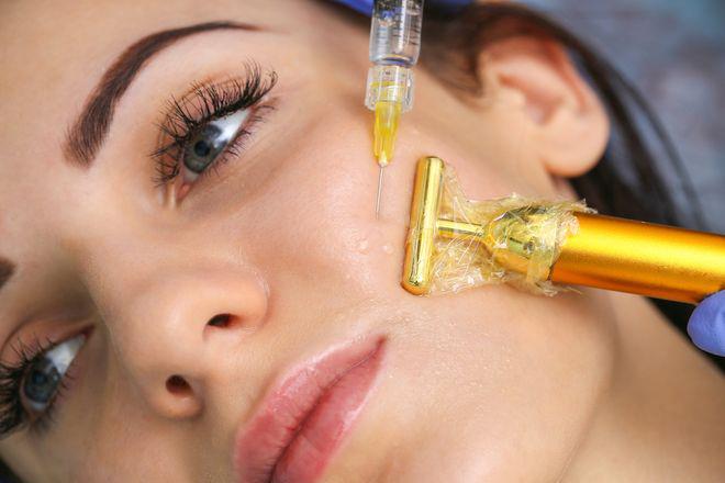 Filler injection in a woman's cheek.