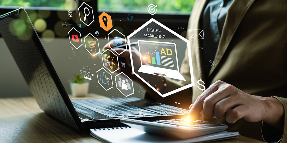 Digital marketer at computer with Maps, YouTube, Facebook, data icons
