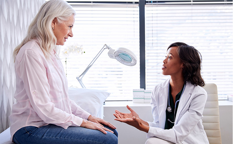 Practitioner discusses menopause therapies with woman patient.
