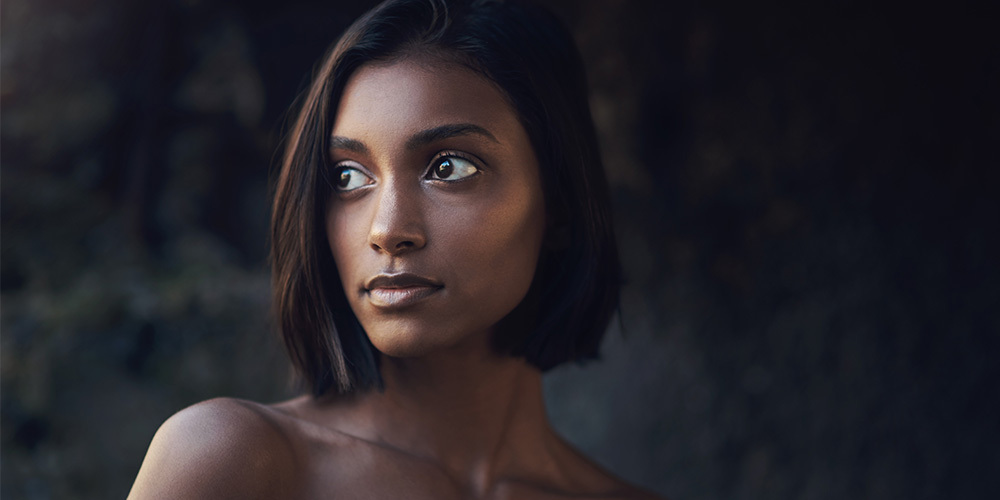 Woman of color looking into distance