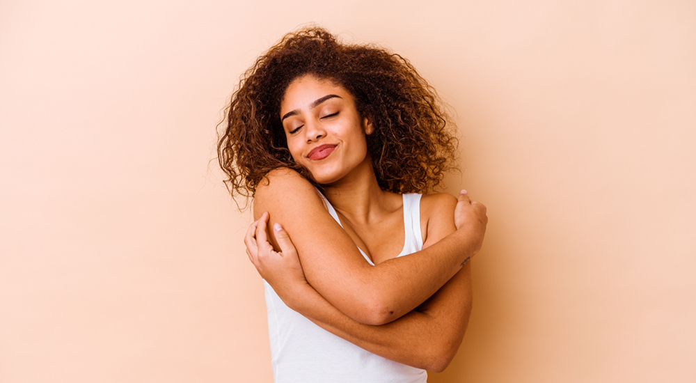 model hugging herself