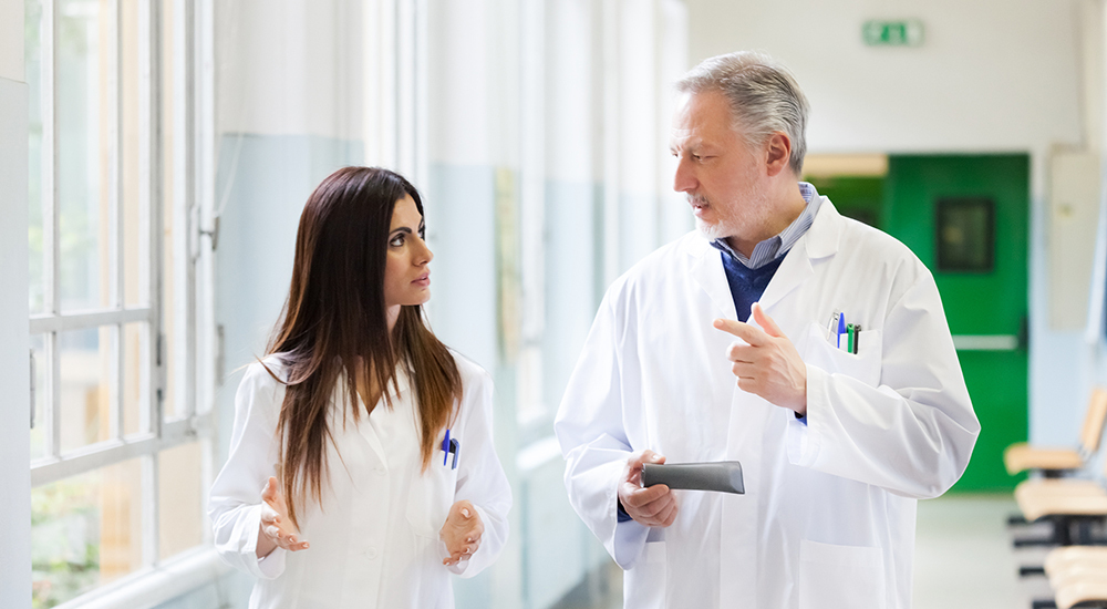 physician speaks with younger practitioner